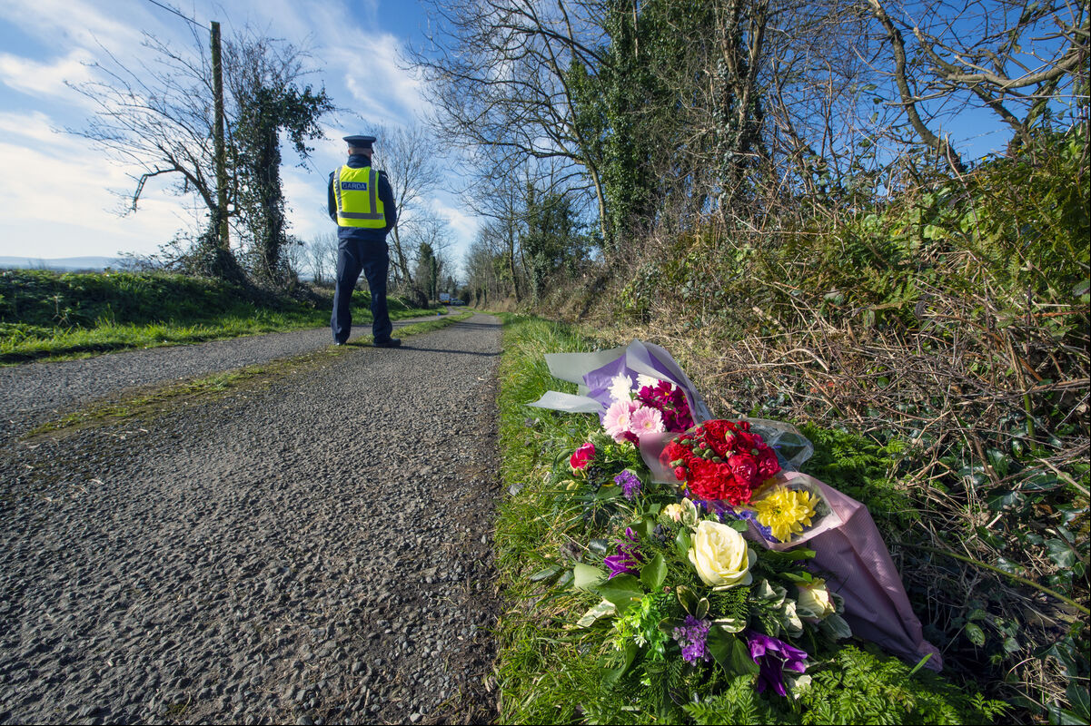 A Garda on duty where neighbours left flowers near the Hennessy family farm at Curraghgorm near Mitchelstown, North Cork where brothers Paddy (60) and Willie (66) were found dead on Friday. Picture Dan Linehan A Garda on duty where neighbours left flowers near the Hennessy family farm at Curraghgorm near Mitchelstown, North Cork where brothers Paddy (60) and Willie (66) were found dead on Friday. Picture Dan Linehan
