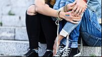 Unrecognizable girls embracing and sitting on stairs