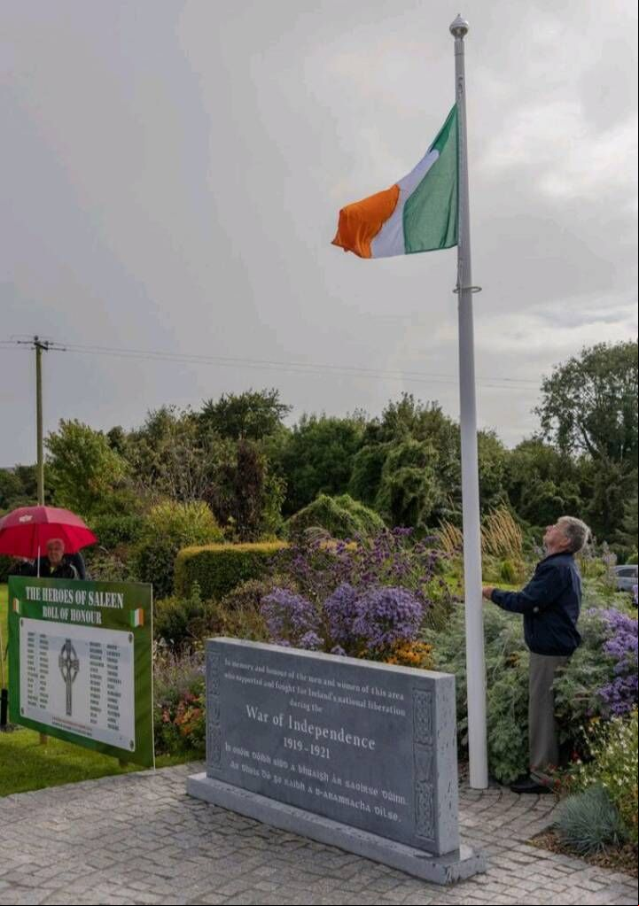 Committee member Jerry O'Brien raising the national flag. Committee member Jerry O'Brien raising the national flag.
