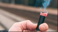 Firecracker Burning in Hand with Sparks and Smoke