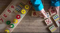 Child playing with mathematical toy