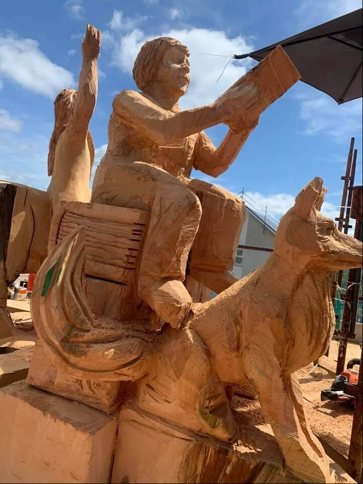 The former local district nurse Julia Singleton as depicted in the carving with her trusty dog, Renti. The former local district nurse Julia Singleton as depicted in the carving with her trusty dog, Renti.