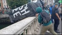 Coffin marked 'RIP British Empire' thrown into Liffey during anti-monarchy march