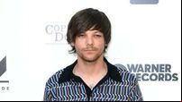 Louis Tomlinson forced to reschedule events after breaking arm in fall