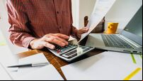 Senior man checking bills at home