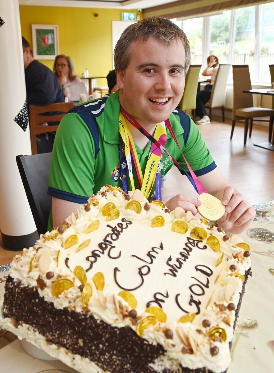 Colm Monahan, a member of the staff at Chapel Gate Café, Ballincollig, run by the Brothers of Charity, during a celebration in his honour in the café on his return with a men's singles gold medal for bton at the Special Olympics World Games. Colm Monahan, a member of the staff at Chapel Gate Café, Ballincollig, run by the Brothers of Charity, during a celebration in his honour in the café on his return with a men's singles gold medal for bton at the Special Olympics World Games.