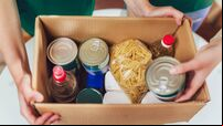 Volunteer with box of food for poor. Donation concept.