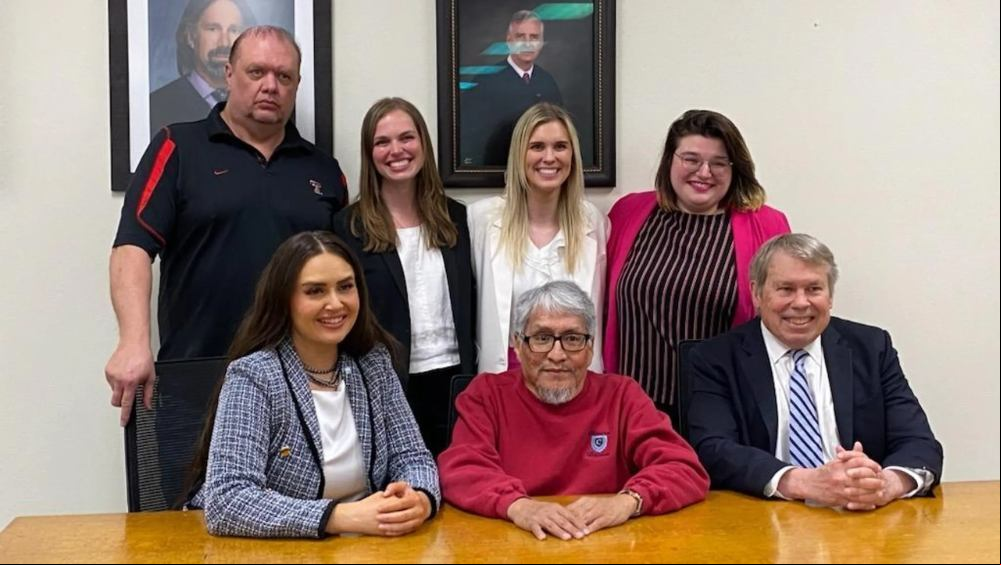 James Reyos, seated front center, next to Allison Clayton, left side, along with the other of the Innocence Project of Texas team that got him exonerated for the murder of Father Patrick Ryan in Odessa in 1981.