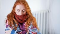 One person feeling cold at home having heating problem