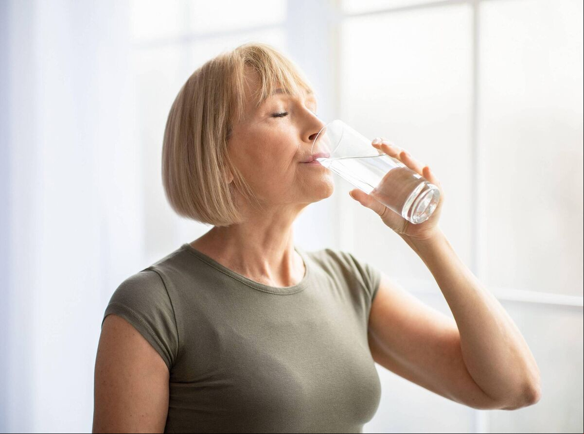 A Generic Photo of woman drinking water from a glass. A Generic Photo of woman drinking water from a glass.