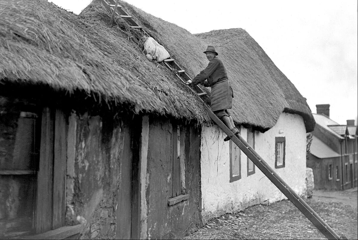 A thatcher at work in Dungourney, East Cork. 7/2/1933. A thatcher at work in Dungourney, East Cork. 7/2/1933.