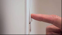 Closeup detail of male finger pushing light switch