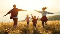 Happy family: mother, father, children son and daughter on sunset