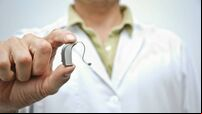 Doctor showing hearing aid