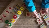 Child playing with mathematical toy