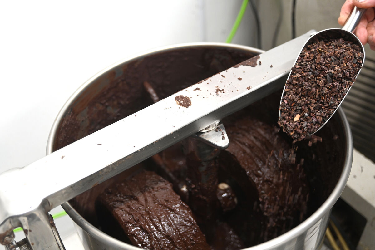 Melanging is the process of grinding the cacao nibs and cane sugar with granite stone wheels until the particle size reaches about 20 microns. Picture: Larry Cummins Melanging is the process of grinding the cacao nibs and cane sugar with granite stone wheels until the particle size reaches about 20 microns. Picture: Larry Cummins
