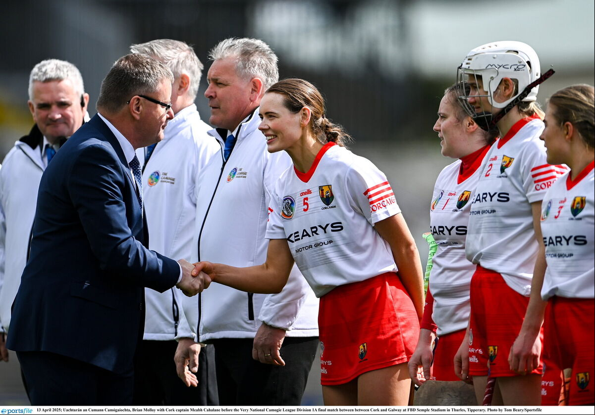 Uachtarán an Cumann Camógaíochta, Brian Molloy with Cork captain Meabh Cahalane. Picture: Tom Beary/Sportsfile