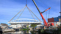 Watch: Pedestrian bridge lifted into place across Cork's Lee