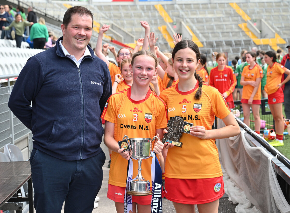  Rebecca Regan, captain, and Molly O'Brien, vice-captain, from Ovens NS with Martin McKeogh of Allianz after winning the Sciath na Scol. Picture: Larry Cummins