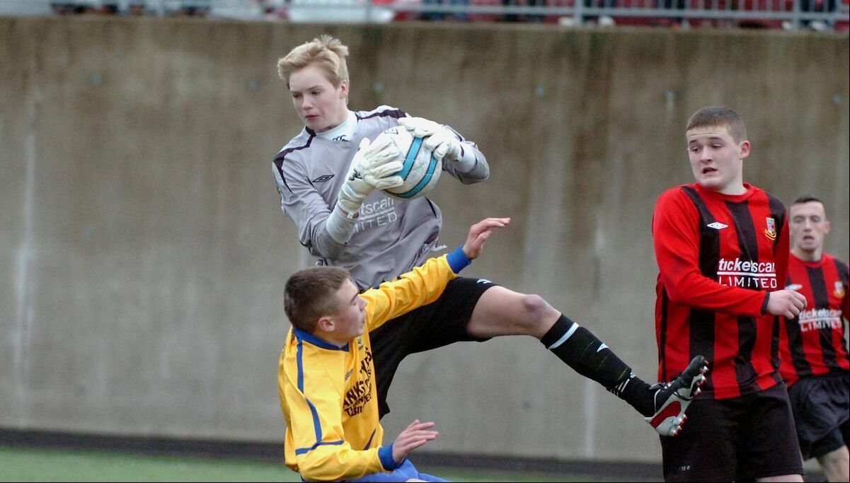 Ringmahon Rangers 'keeper Caoimhin Kelleher claims possession in the air, under pressure from Carrigaline attacker Aaron Drinan in 2013 Ringmahon Rangers 'keeper Caoimhin Kelleher claims possession in the air, under pressure from Carrigaline attacker Aaron Drinan in 2013