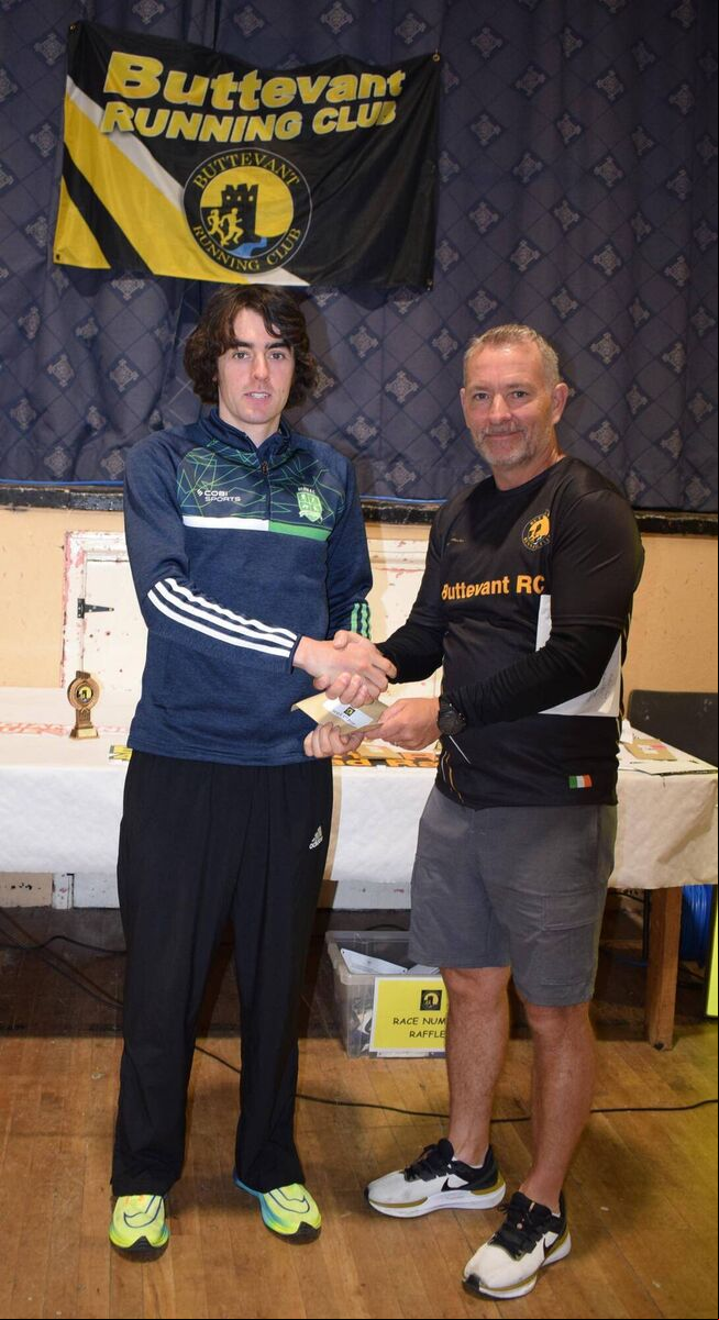 Declan Moore, winner of the Butevant four-mile road race, receiving his prize from Brendan Flanagan, Chairman of Buttevant AC. Picture: John Walshe Declan Moore, winner of the Butevant four-mile road race, receiving his prize from Brendan Flanagan, Chairman of Buttevant AC. Picture: John Walshe