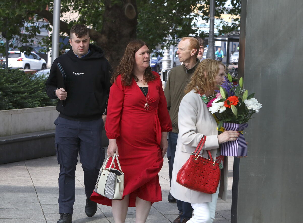 of the Howard family holding flowers arriving at the court today. of the Howard family holding flowers arriving at the court today.
