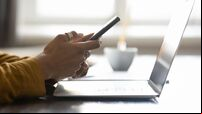 Digital devices on office workplace table of young business woman